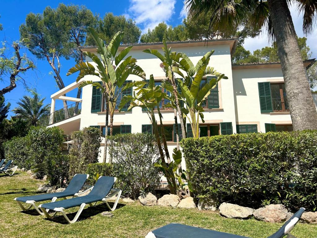 卡尔维亚Beachhouse 2min to the sea with pool & wonderful garden的两把躺椅位于房子前面
