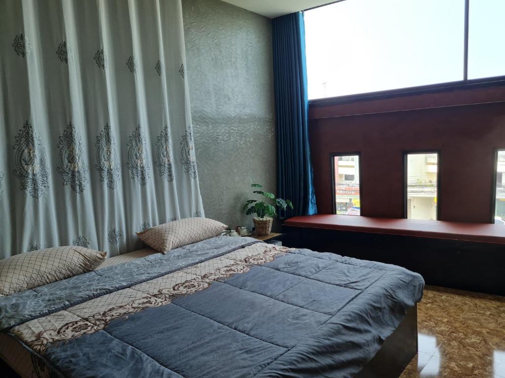 合艾The Greenergy - NO ELEVATOR的一间卧室设有一张大床和一个窗户。