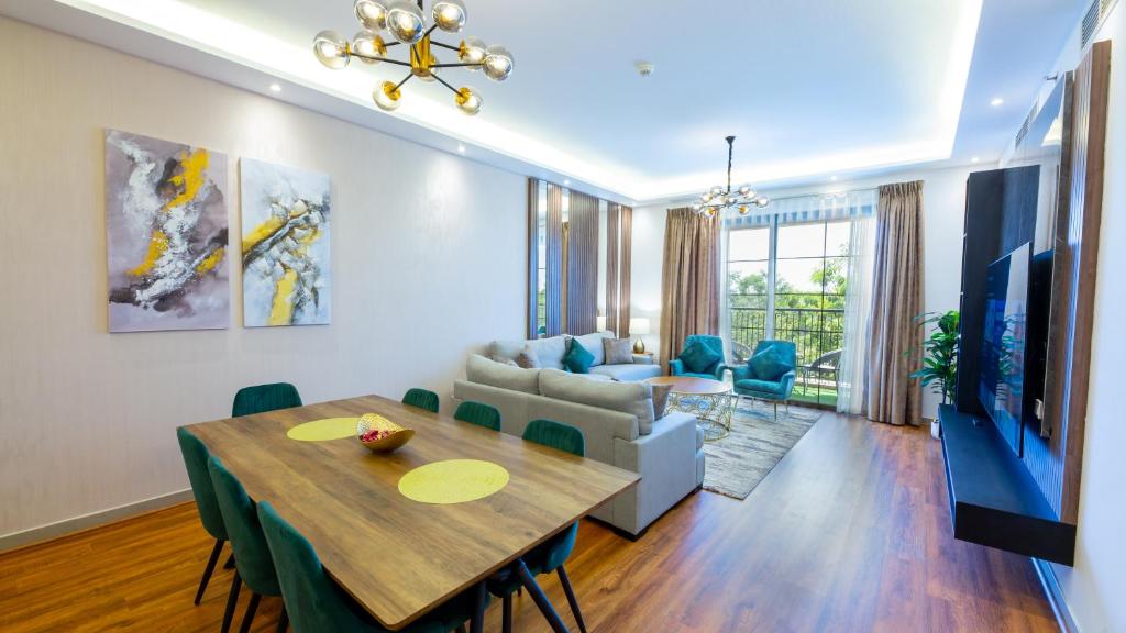 迪拜GOODWOOD SUITES HOMES VACATION的用餐室以及带桌子和沙发的客厅。