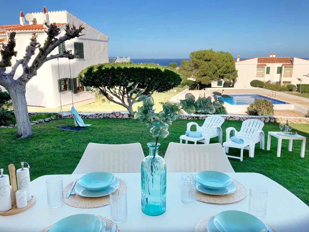 蓬塔格罗萨La Casa del Jardin. Menorca的一张带有蓝色板子的桌子和花瓶