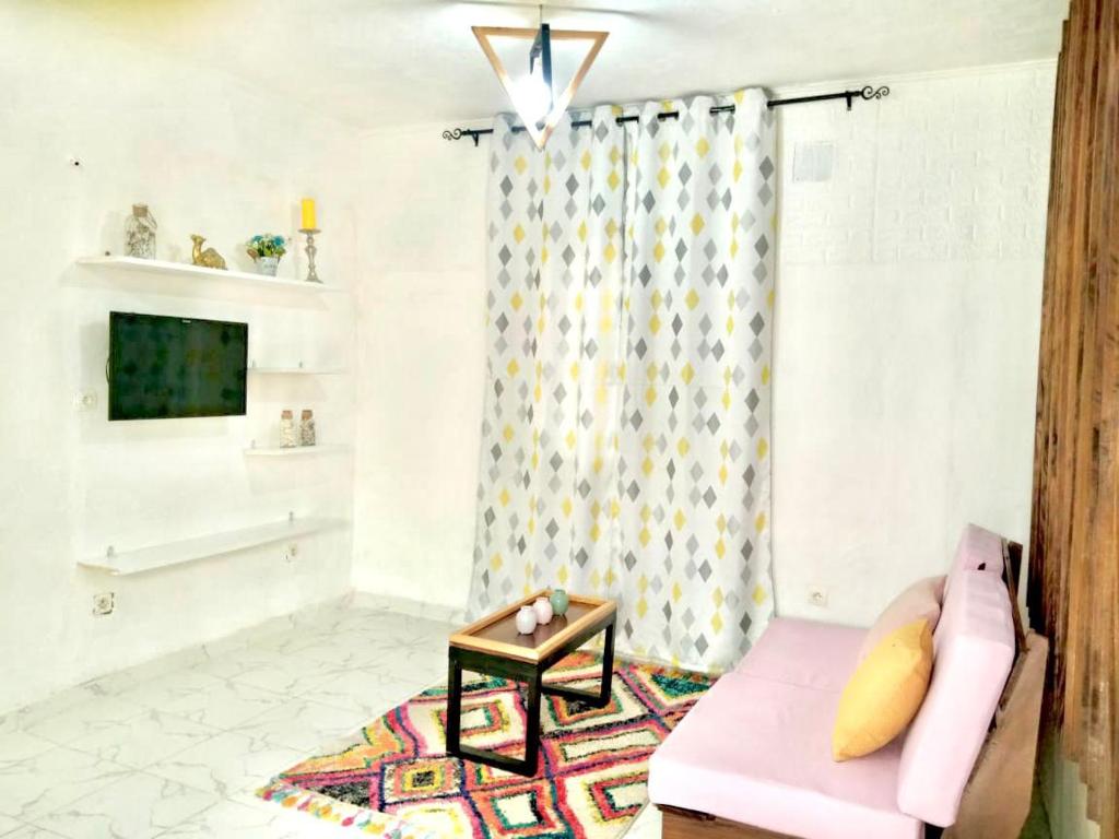 杜阿拉Gêna house的客厅配有粉红色的沙发和桌子