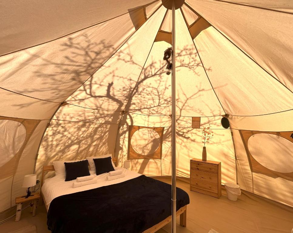 布朗Flore's Garden Glamping的帐篷内一间卧室,配有一张床