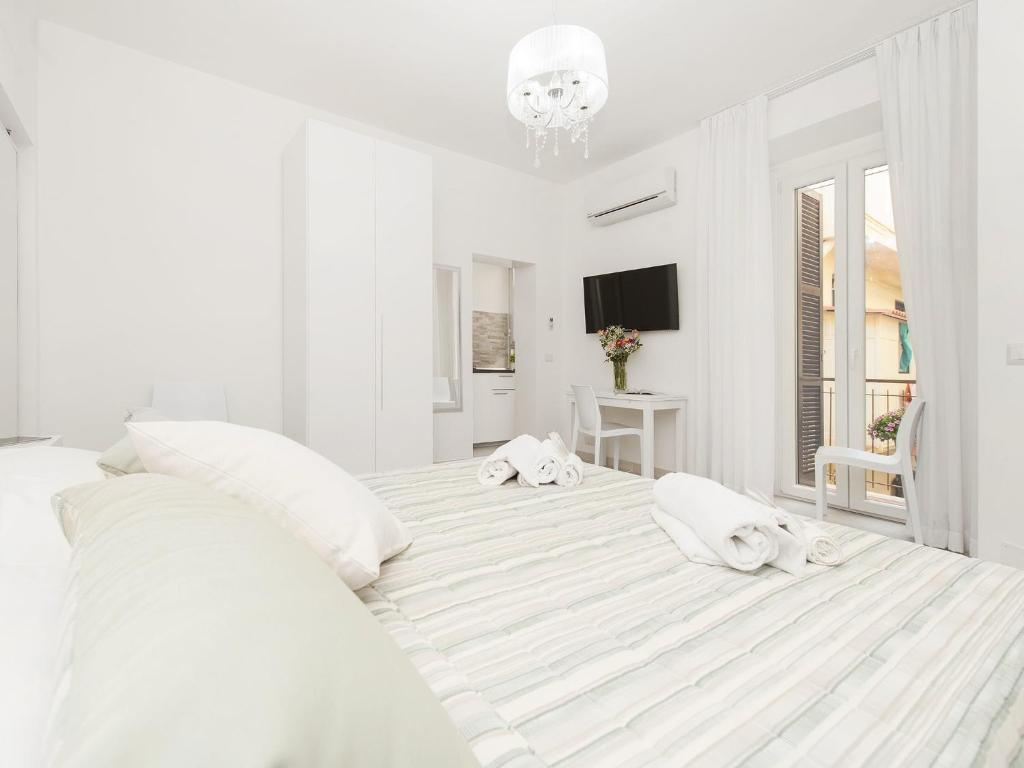 罗马白色特米尼公寓的白色卧室配有一张带白色枕头的大床