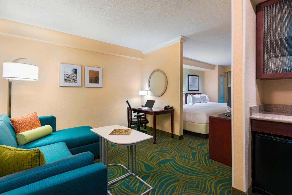 迈尔斯堡迈尔斯堡机场春丘套房酒店的酒店客房设有一张沙发和一张床