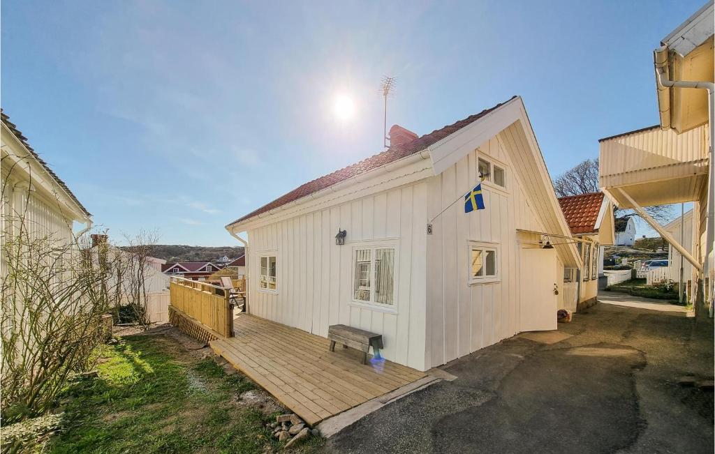 HovenäsetStunning Home In Hovenset With 3 Bedrooms的一座白色的房子,在院子里设有木甲板