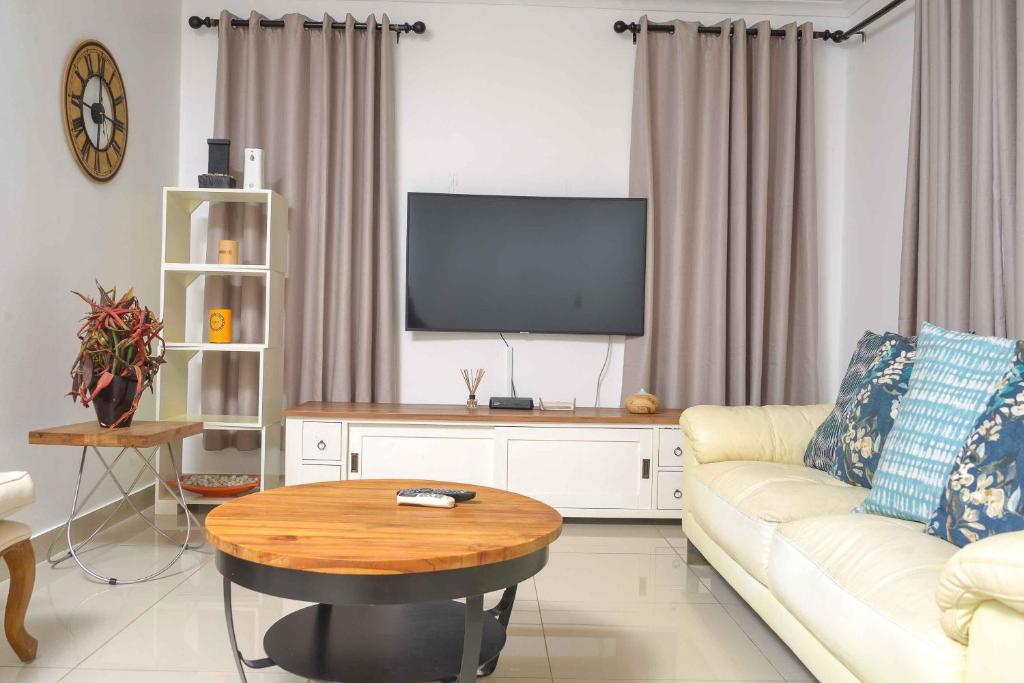 哈博罗内acaciaoptimumstay的带沙发和电视的客厅