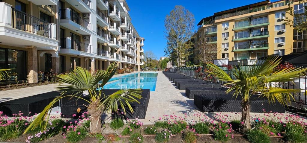 阳光海滩Emilia Romana Park的一排带游泳池和鲜花的建筑