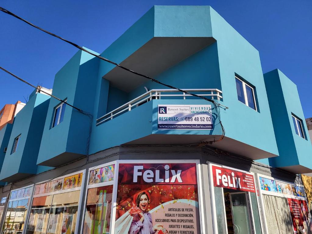 维辛达里奥Resort Suites Vecindario的蓝色的建筑,上面有标志