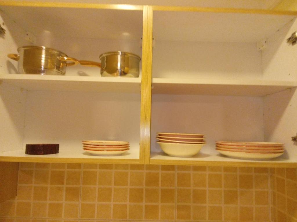 迪拜Paradise Apartment的一个带碗碟的厨房架