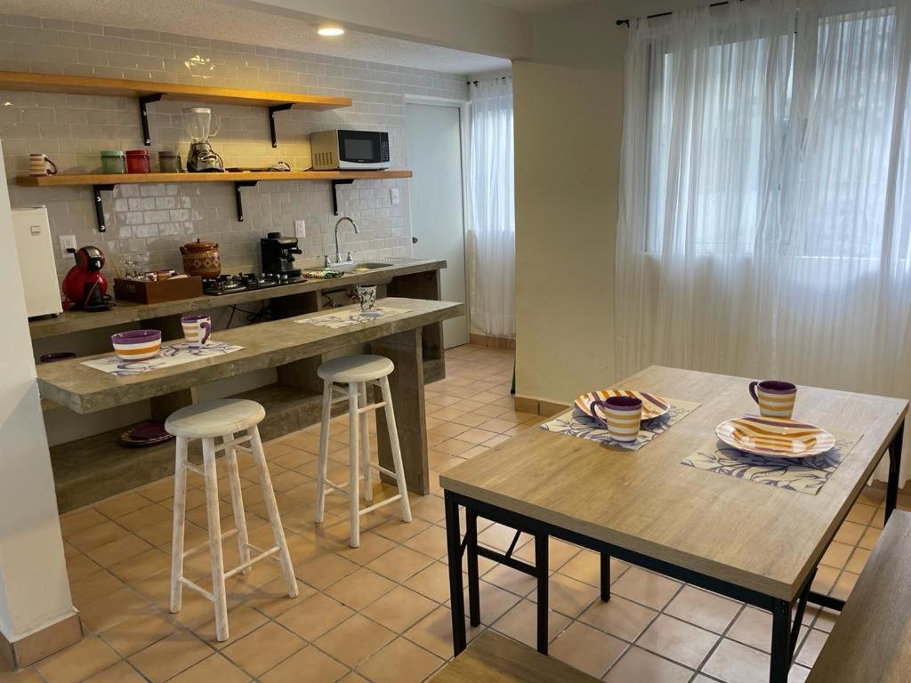 博卡德尔里奥Departamento centro de Boca del Río的厨房配有桌子和2把酒吧凳