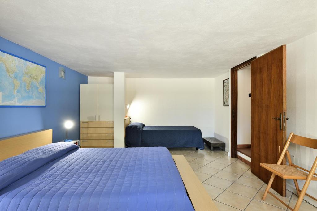 圣玛丽亚纳瓦雷Casa Oleandri的蓝色卧室,配有床和椅子