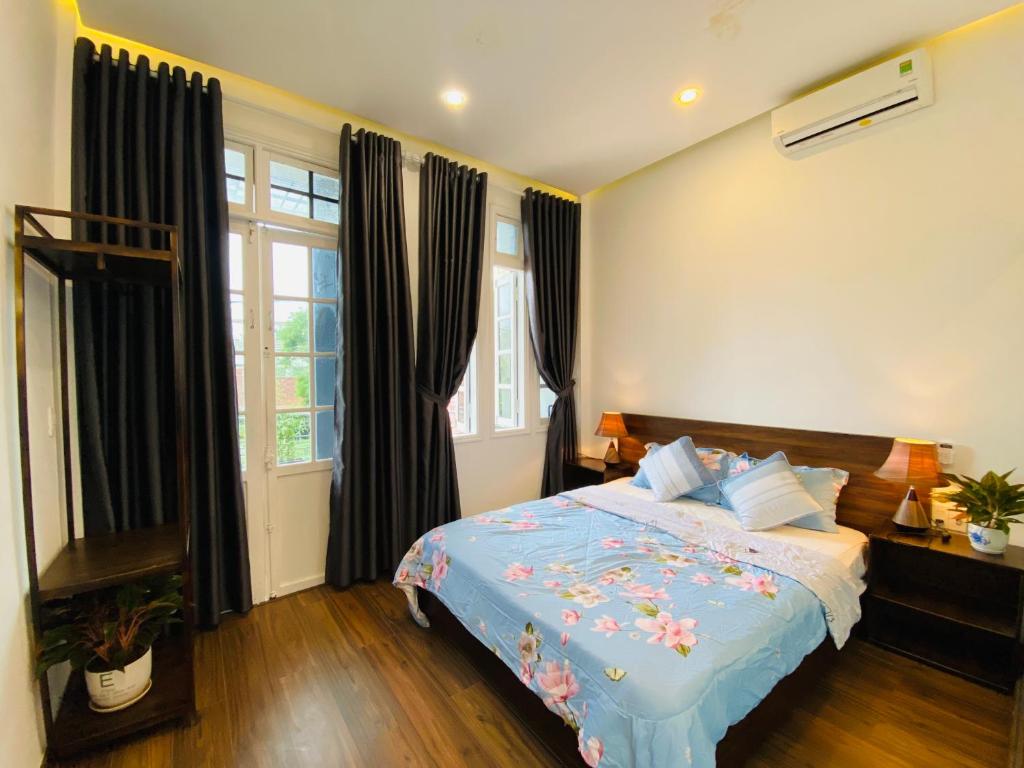 Thôn Kim Long (1)Mia's House Hue的一间卧室配有一张带蓝色棉被的床
