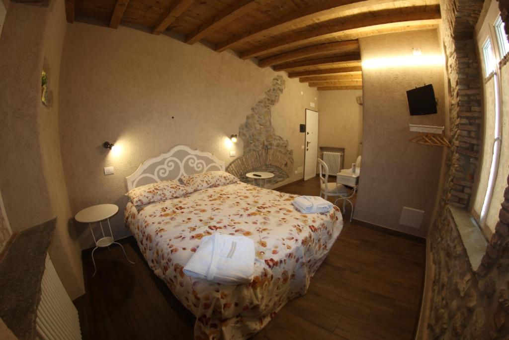 瓦雷泽Locanda Vecchia Osteria的一间卧室,卧室内配有一张大床