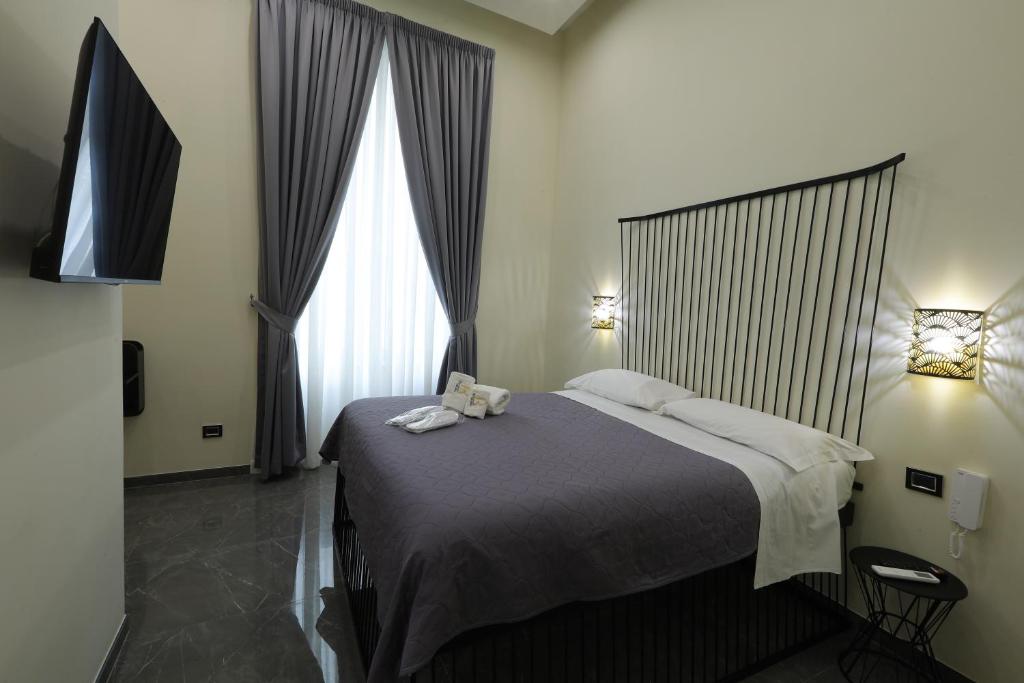 那不勒斯Il Salotto della Regina的一间卧室设有一张床和一个大窗户