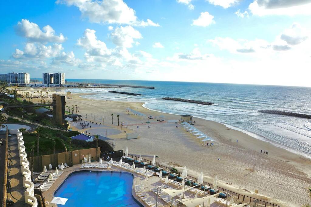 荷兹利亚Daniel Hotel - Residence Seaside Luxury Flat的享有海滩、游泳池和大海的景色