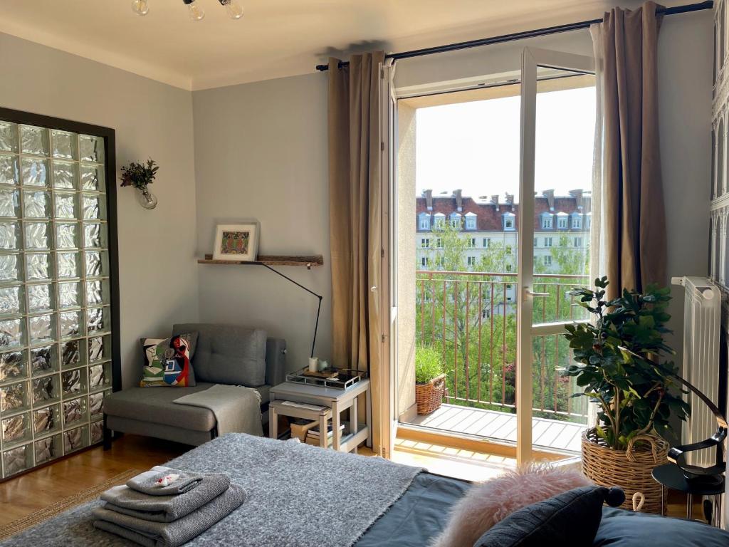 华沙Słoneczny Apartament Koszykowy!的客厅设有床和大窗户