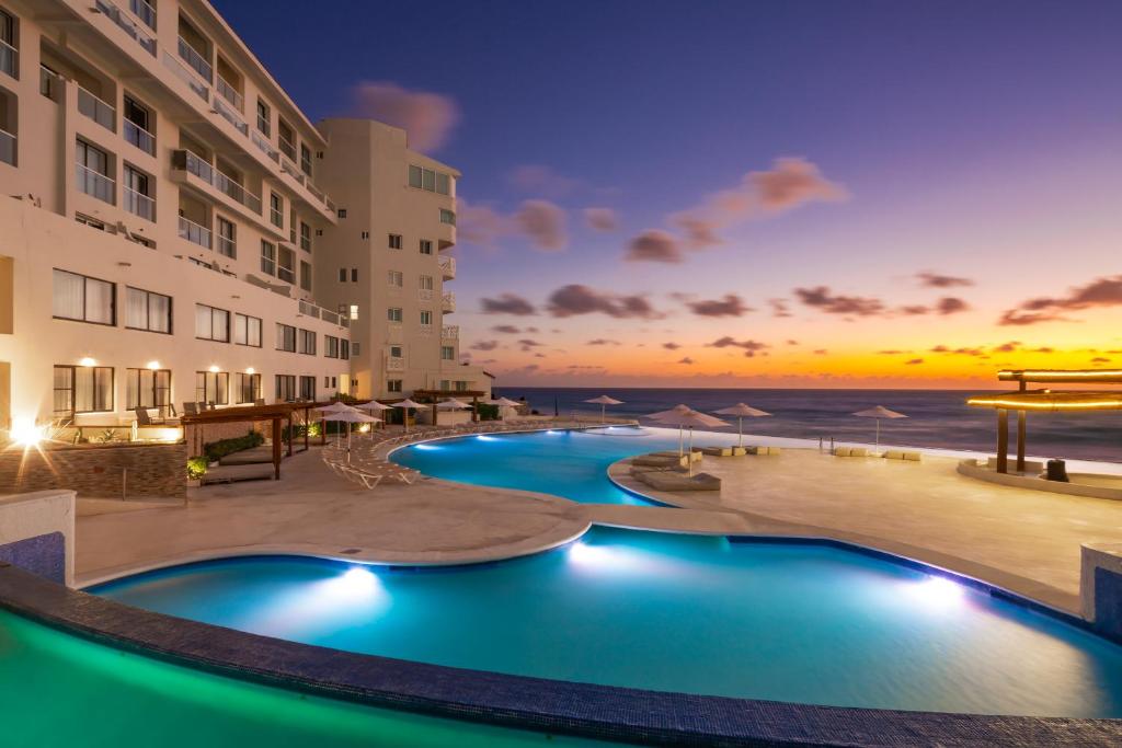 坎昆Cyan Cancun Resort & Spa的享有日落美景的度假游泳池