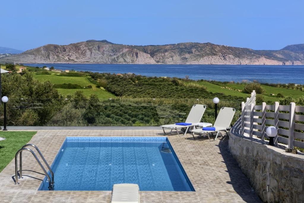 埃皮斯科皮·罗希姆诺Nereid Villa, summer feeling, By ThinkVilla的一个带椅子的游泳池,享有水景