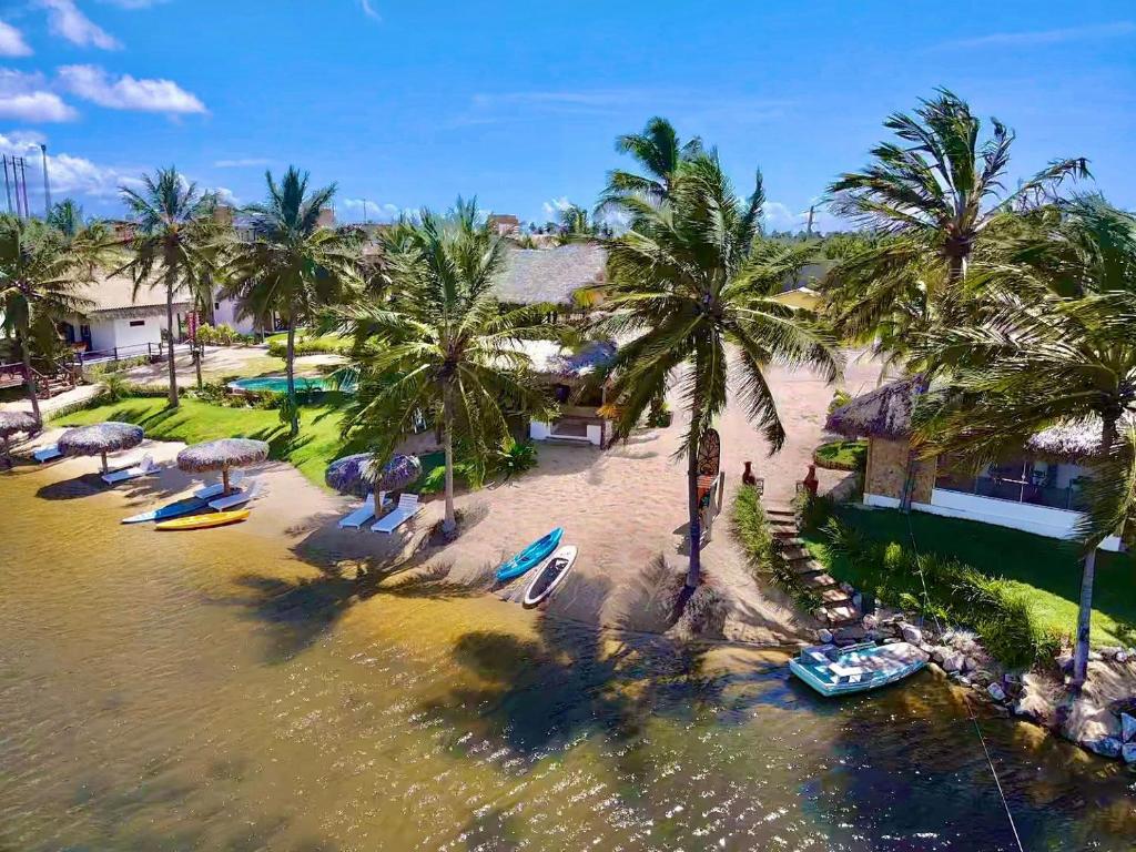 伊卡莱Moriá Eco Lodge的享有棕榈树和船只海滩的空中景致
