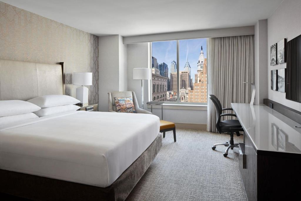 费城费城市中心万豪酒店的配有一张床、一张书桌和一扇窗户的酒店客房