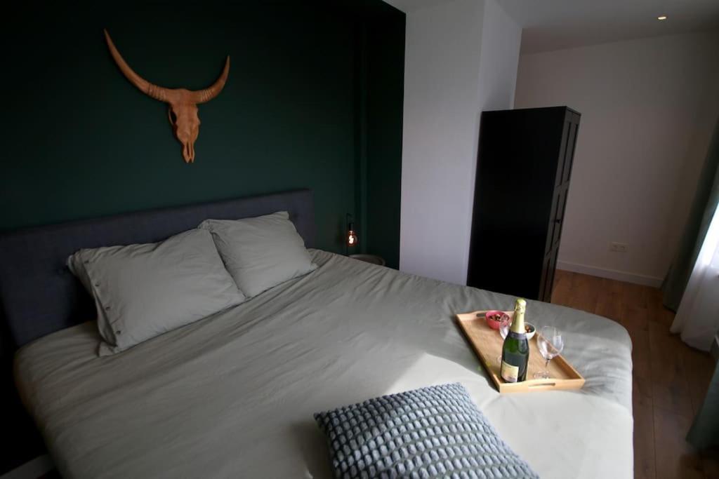 WalsoordenHet Pareltje van Walsoorden的卧室配有一张带鹿头骨的床铺,墙上挂有鹿头