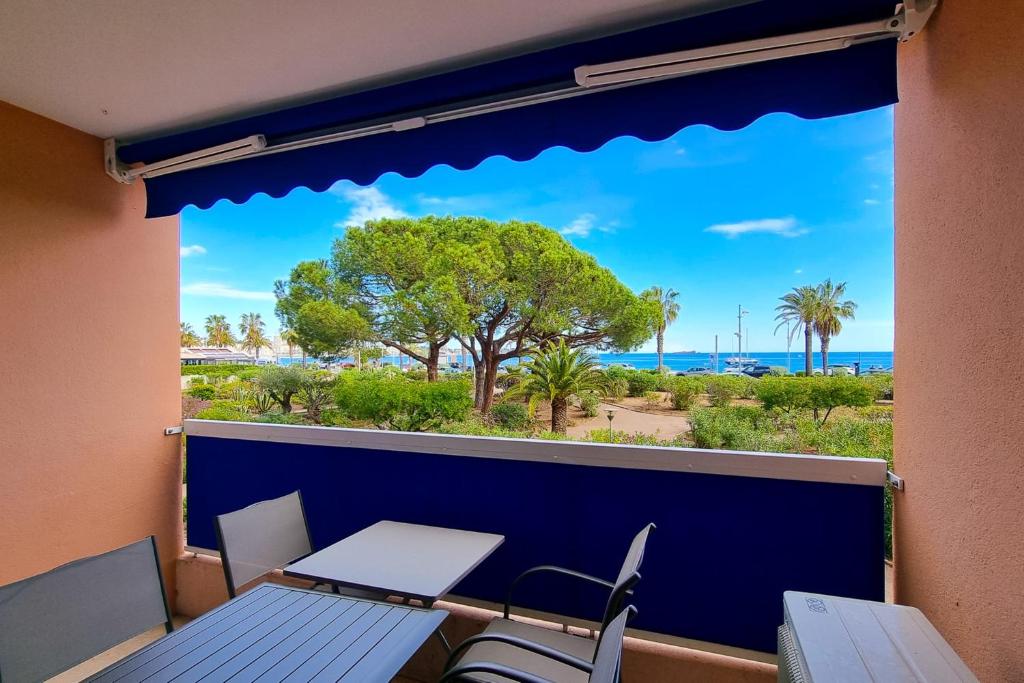 弗雷瑞斯Apartment in Fréjus Plage by the seaside with direct access to the beach的阳台配有桌椅,享有海景。