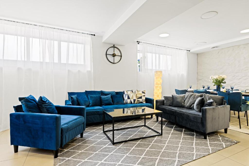 塔林Sirena Apartment - Self check-in and free parking的客厅配有蓝色的沙发和桌子