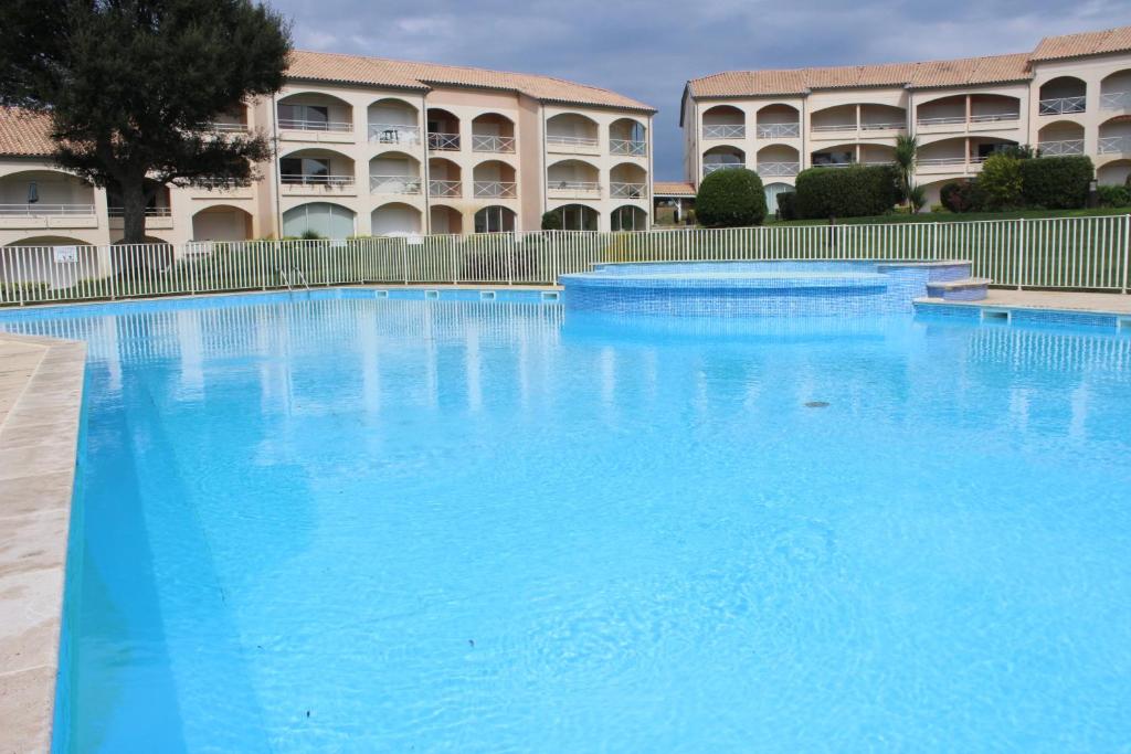 莫列马阿Moliets plage, Résidence OPEN SUD的大楼前的大型蓝色游泳池