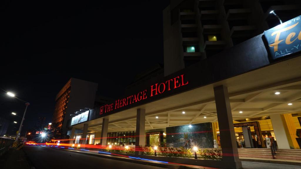 马尼拉The Heritage Hotel Manila的一座建筑,上面有夜间读表演酒店的标志