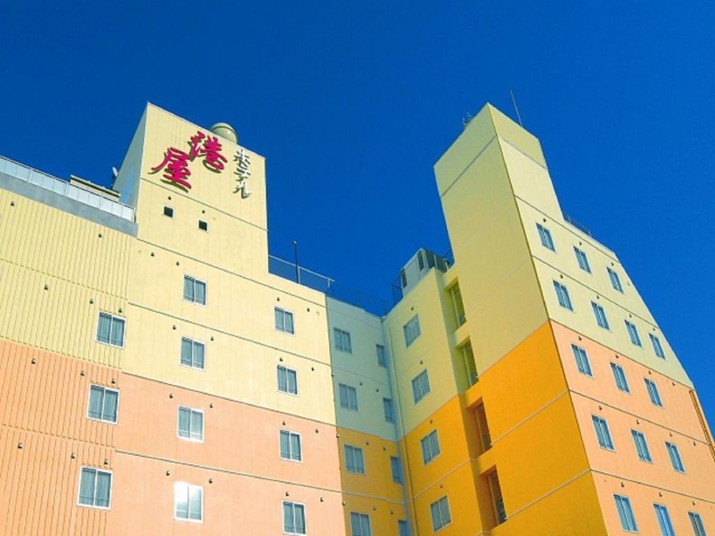 高知米娜托娅酒店的一座大型建筑,上面有两座塔楼