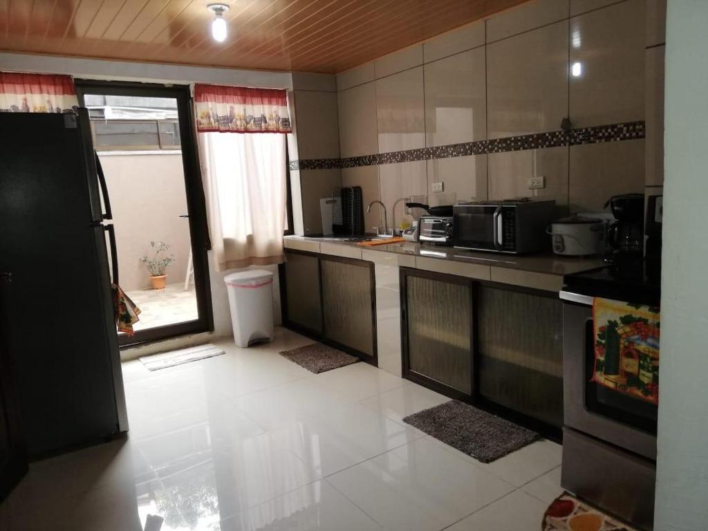 奎波斯城Central 3 Bedroom Quepos Home的厨房配有冰箱和台面