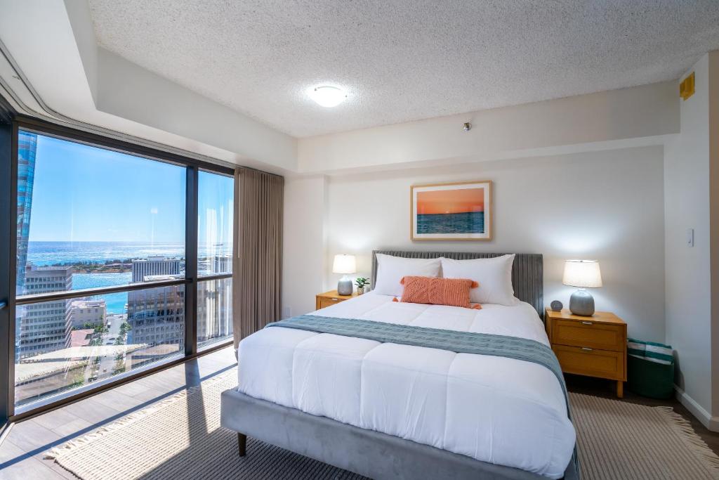 檀香山Stunning Skyview, Pool, Fabulous Location!的一间卧室设有一张大床和一个大窗户
