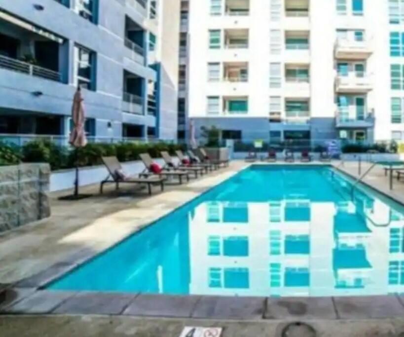 洛杉矶2bedroom Downtown Los Angeles pool and gym onsite.的一座带椅子的大型游泳池和一座建筑