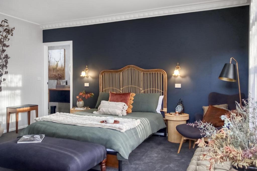吉朗16 Scenic by Regional Escapes的一间卧室设有一张床和蓝色的墙壁