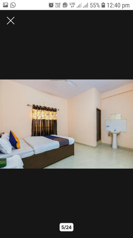 贾巴尔普尔OYO Hotel Erawat Greens的一张带两张床和盥洗盆的卧室的照片