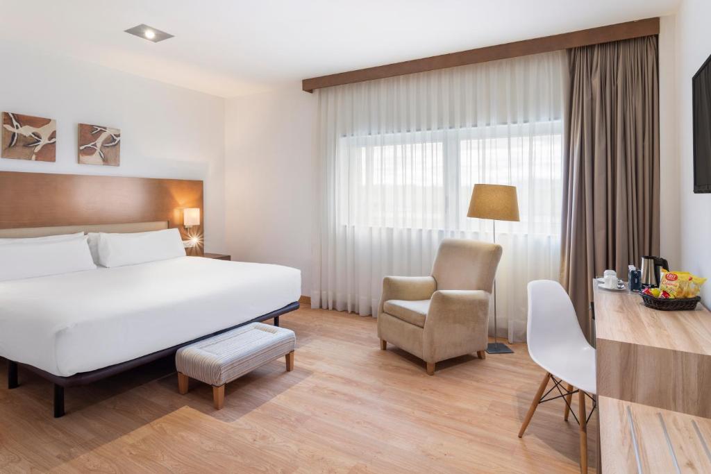 比亚纳B&B HOTEL Logroño Las Cañas的配有一张床和一把椅子的酒店客房