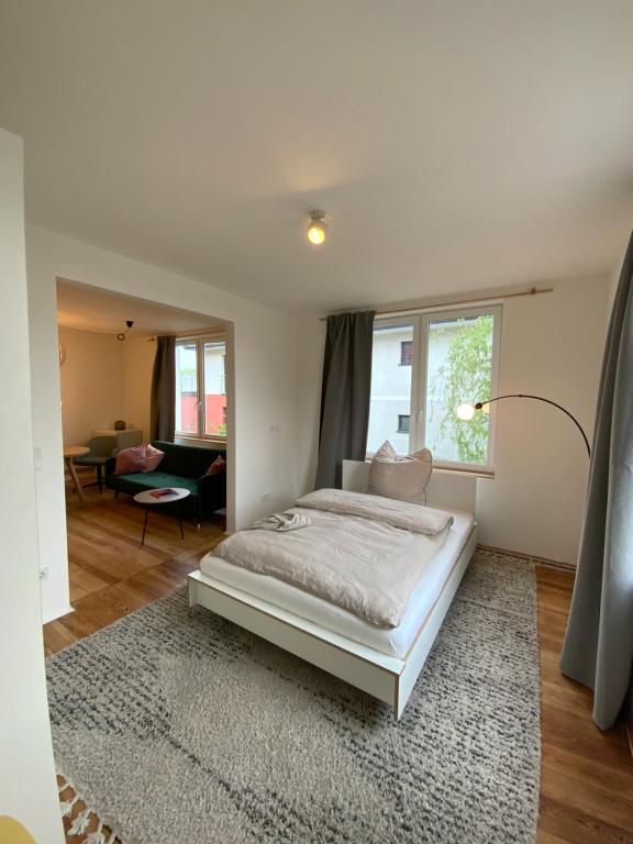 汉堡steenkampstudios GRANNS' SUITE的一间白色的卧室,配有床和客厅