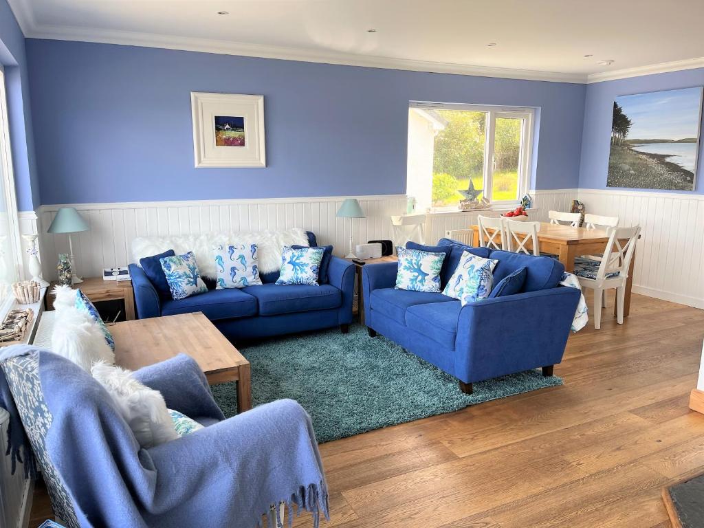 KamesCraignethan的蓝色的客厅配有两张蓝色的沙发和一张桌子
