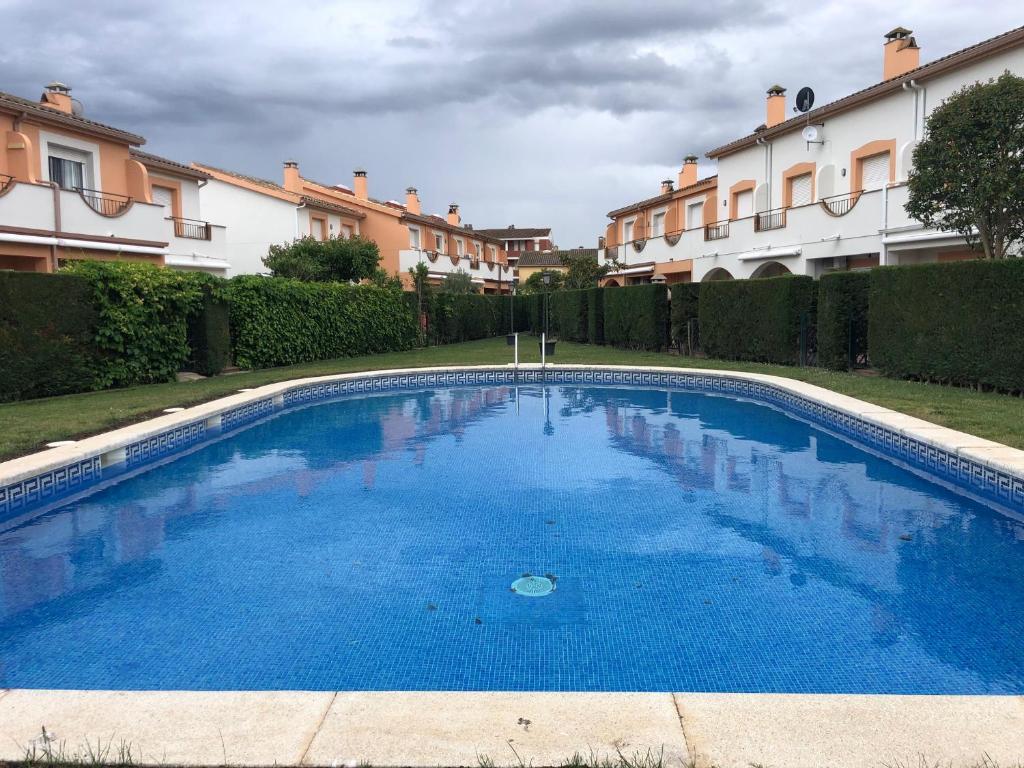 埃斯塔蒂特Casa Sobrestany L’Estartit的一座大型蓝色游泳池,位于部分建筑前