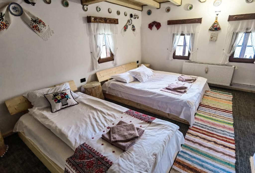 BorsaCăsuța lui Gogu的一间带两张床的卧室和地毯