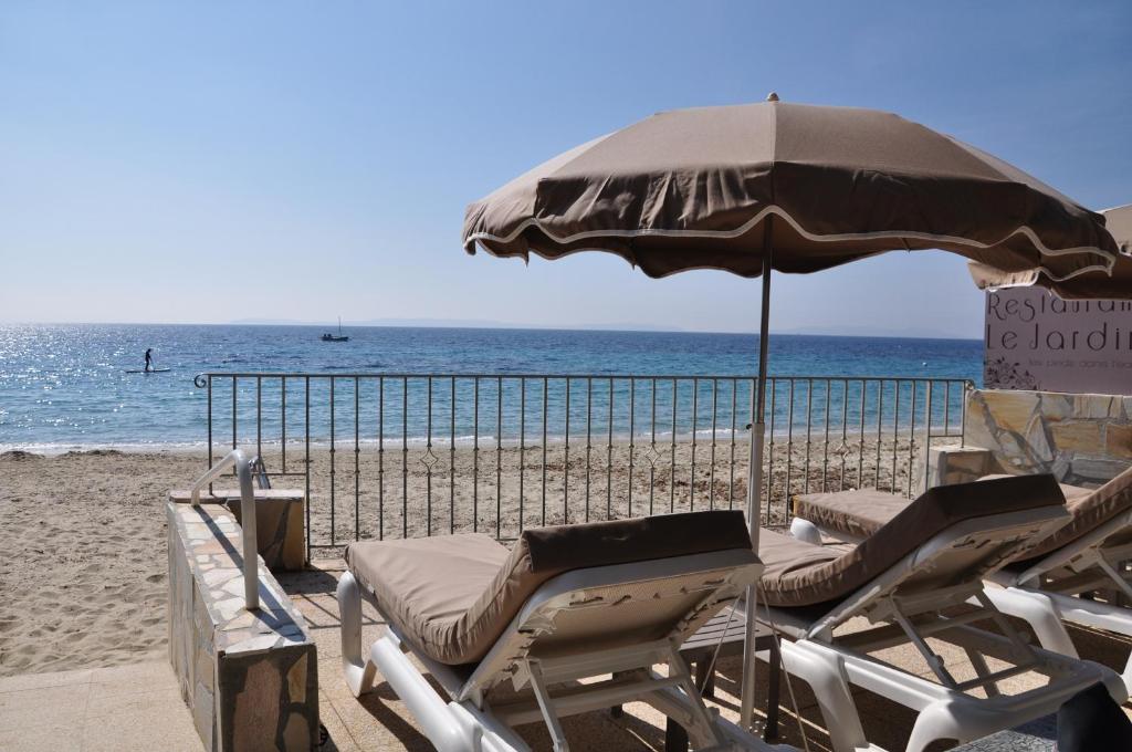 勒拉旺杜海滩酒店的海滩上设有椅子和遮阳伞,大海