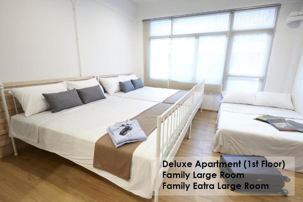 曼谷Platinum Deluxe Shopping Apartments的带窗户的客房内设有两张大床