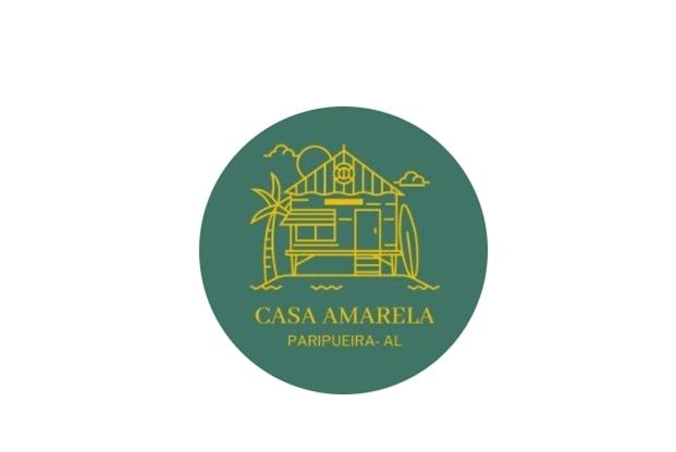 帕里普埃拉Casa Amarela Paripueira的绿色圆圈,有casa amarilla标志