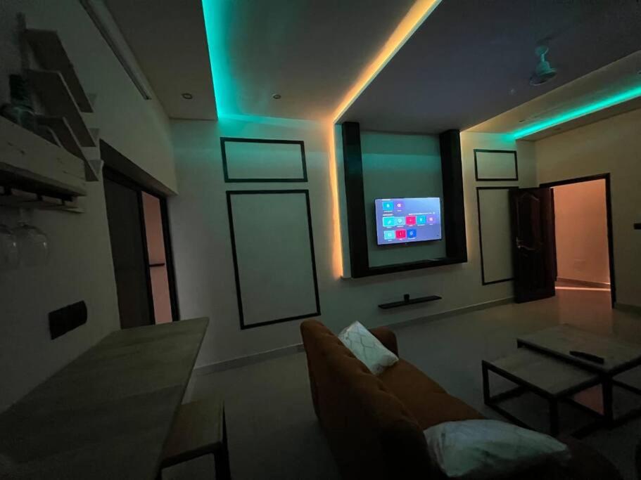 科托努MonGite的带沙发和平面电视的客厅