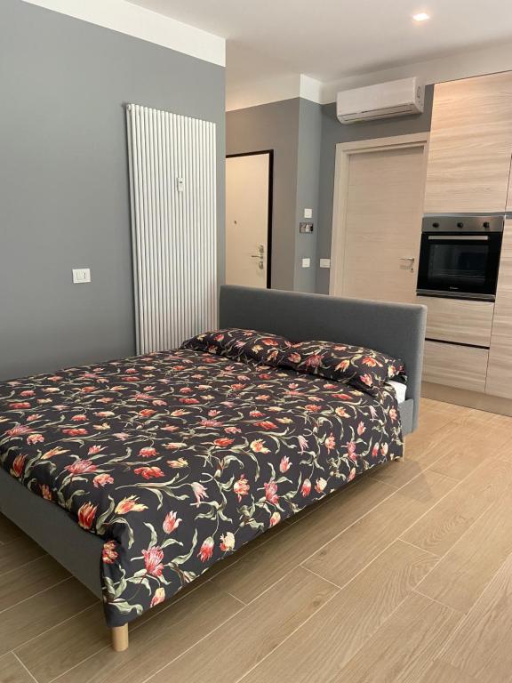 塞格拉泰Casa di Laura mono e bilo di fronte Ospedale San Raffaele的一间卧室配有一张带花卉床罩的床