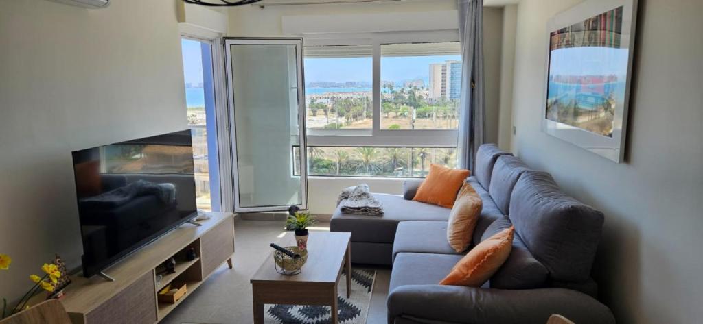 拉曼加戴尔马尔梅纳BEACH SUN SPIRIT, spa & gym的带沙发和大窗户的客厅