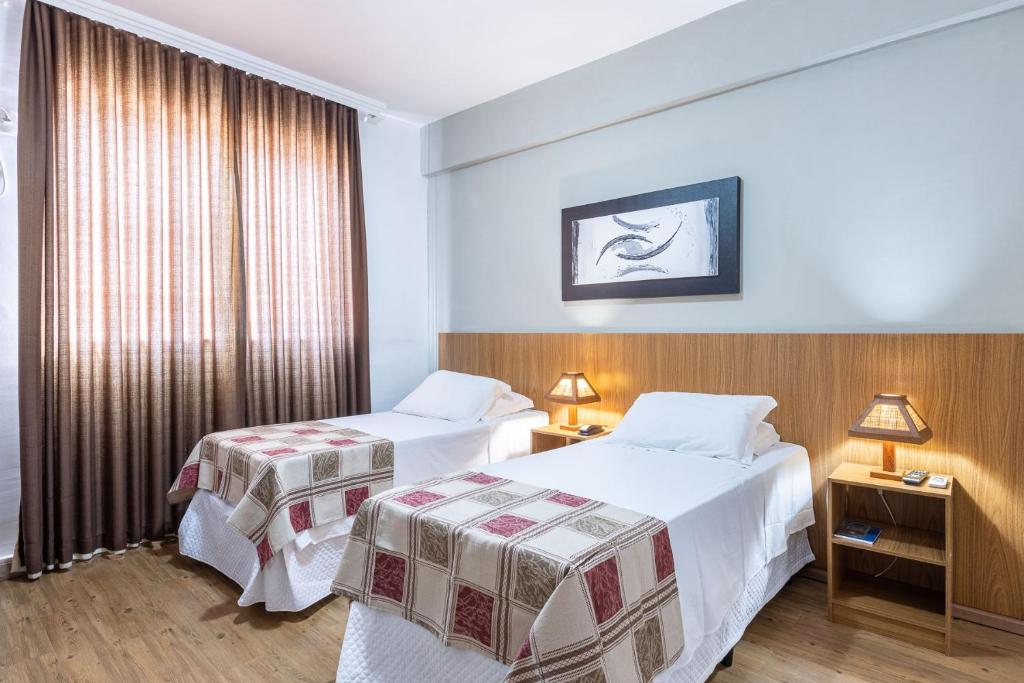 布鲁马迪纽山城酒店的酒店客房设有两张床和窗户。