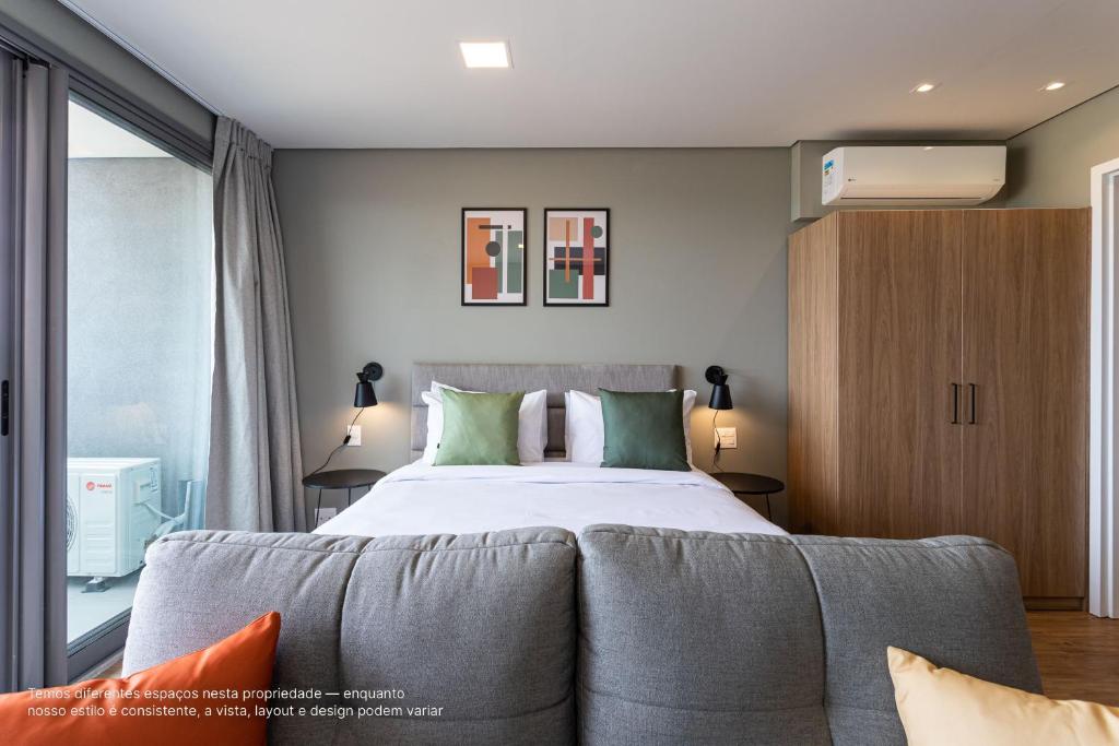 圣保罗Parque Jockey com fácil acesso a Pinheiros e Butantã的一间卧室配有一张带绿色枕头的大床