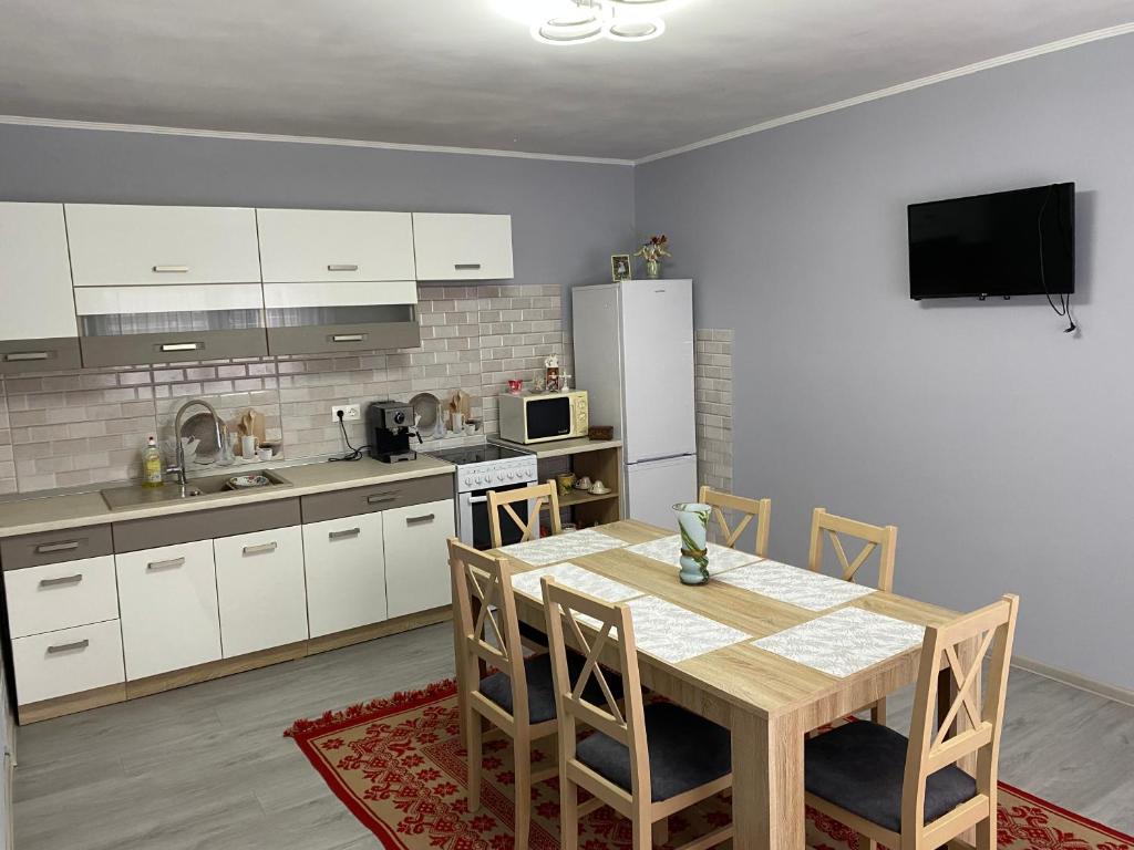 科伦德Anikó kulcsosház的厨房配有桌椅和冰箱。