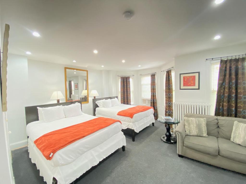 华盛顿Gorgeous Refurbished 1Bdrm and 1Den Home的酒店客房,设有两张床和一张沙发